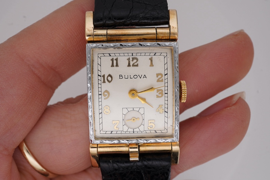 A gentleman's 10k gold filled Bulova manual wind wrist watch, with Arabic dial and subsidiary seconds, case diameter 22mm, on a later associated leather strap. Condition - fair to good.